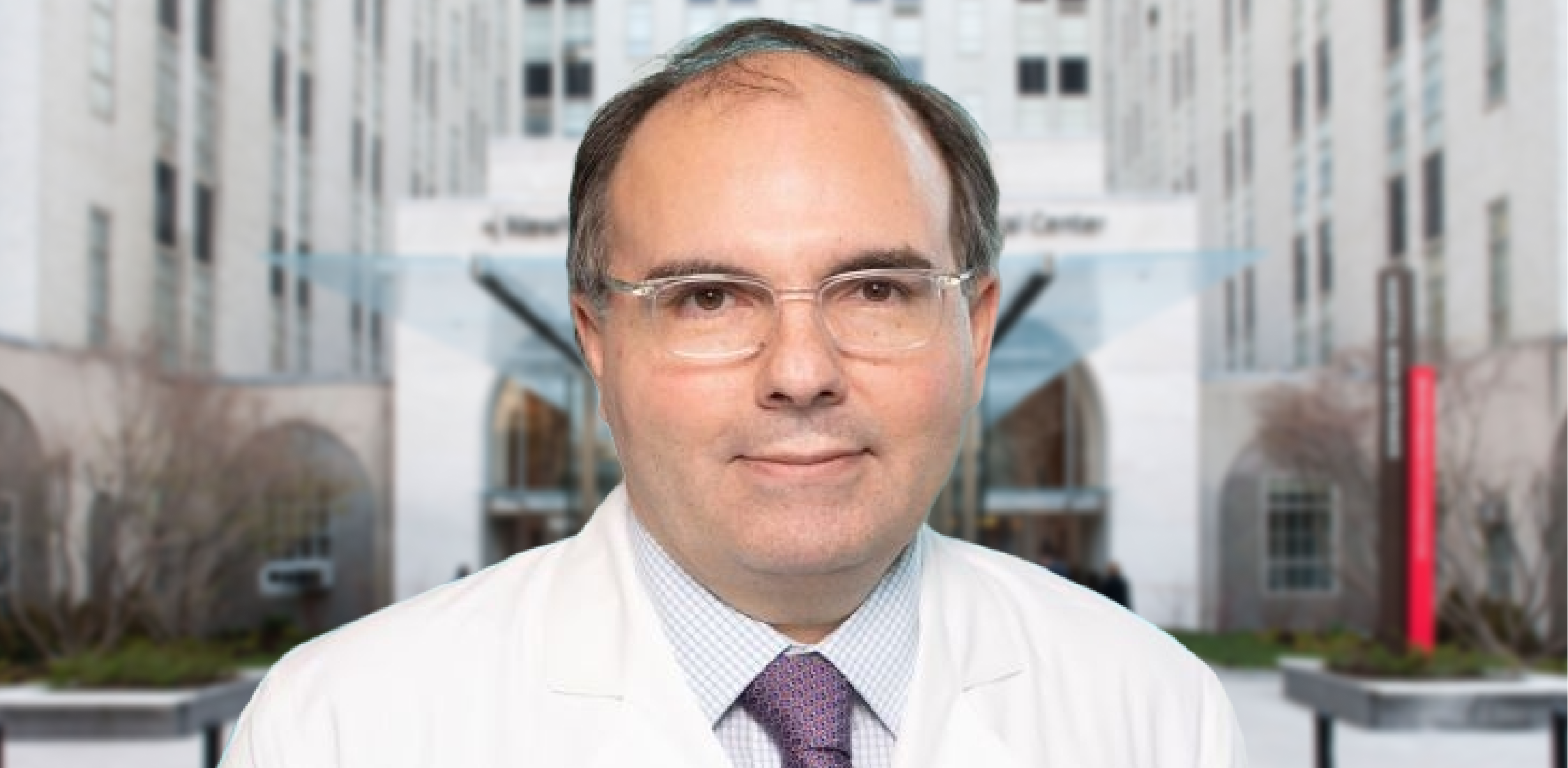 Dr. Juan Pascual, in a white coat and tie, with Weill Cornell Medicine and New York Presbyterian Hospital in the background